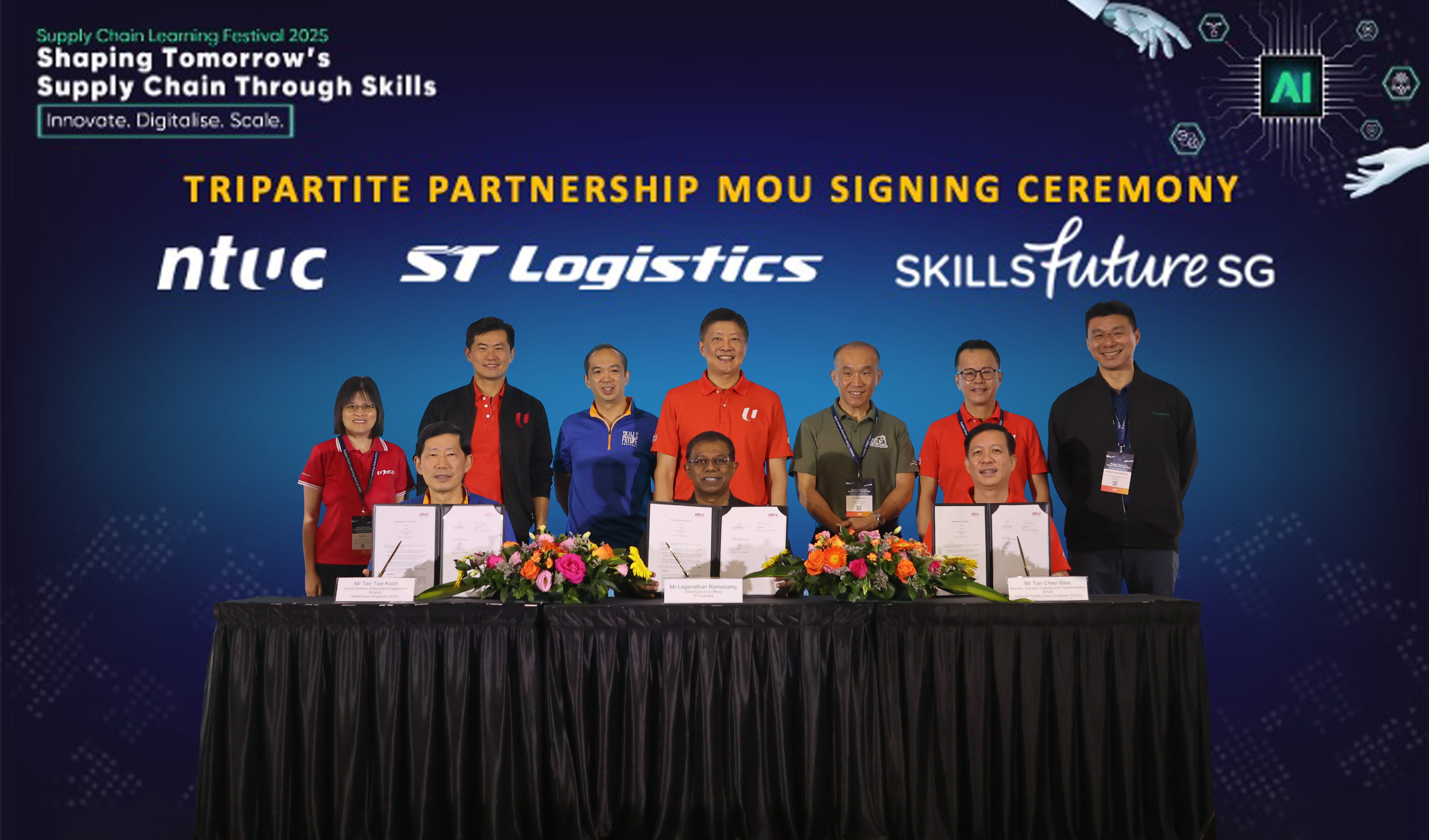 Representatives from SSG, NTUC and ST Logistics posing for a picture on stage after signing the MOU